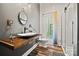 Charming bathroom featuring a vessel sink on a wood countertop and a glass-enclosed shower at 8014 Kiwi Pt, Tega Cay, SC 29708