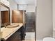 Modern bathroom featuring granite countertop, a glass-enclosed shower with dark tile, and sleek fixtures at 8014 Kiwi Pt, Tega Cay, SC 29708