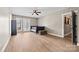 Minimalist bedroom featuring a platform bed, ceiling fan, light wood floors, and French doors leading to the outside at 8014 Kiwi Pt, Tega Cay, SC 29708