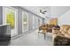 Cozy bonus room with neutral walls, comfortable seating, and ample natural light from the many windows at 8014 Kiwi Pt, Tega Cay, SC 29708