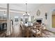Bright dining area with a large dining table, fireplace, and abundant natural light from the multiple windows at 8014 Kiwi Pt, Tega Cay, SC 29708