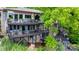 Multi-level home featuring multiple decks, outdoor seating, and wooded surroundings at 8014 Kiwi Pt, Tega Cay, SC 29708