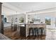 Open-concept kitchen with stone accent island, barstool seating, and seamless flow to the living area at 8014 Kiwi Pt, Tega Cay, SC 29708