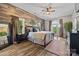 Beautiful main bedroom suite with wood paneling, ceiling fan, and balcony access at 8014 Kiwi Pt, Tega Cay, SC 29708