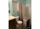 Compact bathroom with a combined tub and shower unit, featuring coordinated decor and a window at 806 Dale Ave, Charlotte, NC 28216