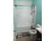 Clean bathroom featuring a shower-tub combo with bright, blueish walls and a tiled floor at 806 Dale Ave, Charlotte, NC 28216
