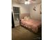 Comfortable bedroom with neutral carpet, a plush upholstered headboard, and a decorative art piece at 806 Dale Ave, Charlotte, NC 28216