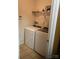 Convenient laundry room featuring a washer, dryer, tiled floors, and built-in shelving for storage at 806 Dale Ave, Charlotte, NC 28216