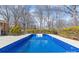 Inviting in-ground pool with a pristine blue surface, surrounded by lush landscaping at 809 E 23Rd Street St, Newton, NC 28658