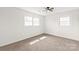 This bedroom has new carpet, two windows and a ceiling fan at 809 E 23Rd Street St, Newton, NC 28658