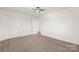 Bright bedroom features neutral carpet, ceiling fan, and closet for ample storage at 809 E 23Rd Street St, Newton, NC 28658