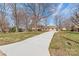 View of the home from across the lawn, focusing on the long concrete driveway leading up to the residence at 809 E 23Rd Street St, Newton, NC 28658