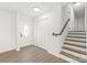 Inviting foyer featuring wood-look floors, white trim, a staircase, and a front door with decorative glass at 809 E 23Rd Street St, Newton, NC 28658