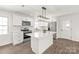 Modern kitchen with stainless steel appliances, island, and sleek white cabinetry; a chef's dream at 809 E 23Rd Street St, Newton, NC 28658