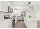 Modern all-white kitchen featuring stainless steel appliances, sleek countertops, and stylish pendant lighting at 809 E 23Rd Street St, Newton, NC 28658