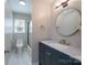 Bathroom with modern vanity, sleek fixtures, and a combined shower and tub at 8201 Tonawanda Dr, Charlotte, NC 28277