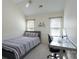 Well-lit bedroom with a cozy bed and a modern desk setup, perfect for a comfortable and functional space at 8201 Tonawanda Dr, Charlotte, NC 28277