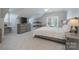 Attic bedroom features cozy decor, a dresser, a window, and an area rug at 8201 Tonawanda Dr, Charlotte, NC 28277