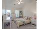 Bright bedroom with a bed, a work desk, a dresser, and two windows at 8201 Tonawanda Dr, Charlotte, NC 28277