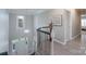 Bright foyer features chandelier lighting, hardwood floors, and a staircase with black metal spindles at 8201 Tonawanda Dr, Charlotte, NC 28277