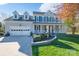 Charming two-story home with a well-manicured lawn, a welcoming front porch, and an attached two-car garage at 8201 Tonawanda Dr, Charlotte, NC 28277