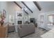 Cozy living room featuring a fireplace, beamed ceilings, and views to the outdoor patio at 8201 Tonawanda Dr, Charlotte, NC 28277