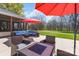 Inviting patio area featuring stylish outdoor furniture and vibrant red umbrellas for comfortable outdoor living at 8201 Tonawanda Dr, Charlotte, NC 28277