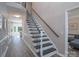 Elegant staircase featuring dark wood steps, white risers, and a stylish metal railing, enhancing the home's interior at 8201 Tonawanda Dr, Charlotte, NC 28277