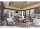 Bright sunroom features tile floors, ceiling fans, and views of a lush backyard at 8201 Tonawanda Dr, Charlotte, NC 28277