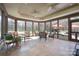 Bright sunroom features tile floors, ceiling fans, and backyard views at 8201 Tonawanda Dr, Charlotte, NC 28277