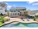 Expansive backyard featuring a pool, patio, lounge chairs, and a covered outdoor dining area at 8511 Fox Tail Ln, Huntersville, NC 28078