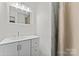 Modern bathroom features a double sink vanity, large mirror, and a shower with glass doors at 8511 Fox Tail Ln, Huntersville, NC 28078