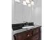 Elegant bathroom features a dark wood vanity with a black countertop at 8511 Fox Tail Ln, Huntersville, NC 28078