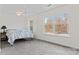 Bright bedroom with large windows, ceiling fan, carpeted floors, and a tranquil view at 8511 Fox Tail Ln, Huntersville, NC 28078