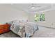 Bedroom with tray ceiling, ceiling fan, and window with treed exterior view at 8511 Fox Tail Ln, Huntersville, NC 28078