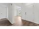 A bright entryway showcases the home's open floor plan, hardwood floors, and large entry door at 8511 Fox Tail Ln, Huntersville, NC 28078