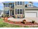 Charming two-story home with sage green siding, black shutters, and a cozy front patio at 8511 Fox Tail Ln, Huntersville, NC 28078