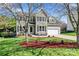 Charming two-story home with a well-manicured lawn, beautiful landscaping, and a two-car garage at 8511 Fox Tail Ln, Huntersville, NC 28078