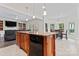 Kitchen island featuring granite countertops with built-in dishwasher at 8511 Fox Tail Ln, Huntersville, NC 28078