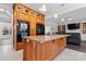 Open kitchen with a granite island, custom cabinets, stainless steel appliances, and hardwood flooring at 8511 Fox Tail Ln, Huntersville, NC 28078