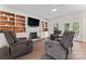 Cozy living room with a fireplace, custom built-ins, hardwood floors and comfortable seating at 8511 Fox Tail Ln, Huntersville, NC 28078