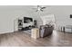 Spacious living room with hardwood floors, a ceiling fan, and natural lighting at 8511 Fox Tail Ln, Huntersville, NC 28078