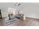 Spacious living room with hardwood floors, a ceiling fan, and natural lighting at 8511 Fox Tail Ln, Huntersville, NC 28078