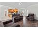 Open-concept living room showcasing hardwood floors and comfortable seating at 8511 Fox Tail Ln, Huntersville, NC 28078