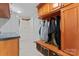 Convenient mud room with bench, storage baskets, and coat hooks for organization at 8511 Fox Tail Ln, Huntersville, NC 28078
