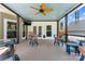 Relaxing screened-in porch area with fan, comfortable seating, and views of the backyard at 8511 Fox Tail Ln, Huntersville, NC 28078