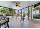 Relaxing screened-in porch area with fan, comfortable seating, and views of the backyard and pool at 8511 Fox Tail Ln, Huntersville, NC 28078
