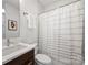 Bathroom featuring a modern vanity, tiled walls, and a shower with a white curtain at 914 Greenleaf Ave # A, Charlotte, NC 28202