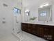 Sleek bathroom with a glass shower, double sinks, modern vanity, and bright lighting at 914 Greenleaf Ave # A, Charlotte, NC 28202