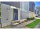 Modern home exterior featuring a vibrant blue door, stone walkway, and manicured landscaping at 914 Greenleaf Ave # A, Charlotte, NC 28202